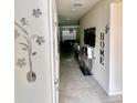 Bright foyer with tile flooring, decorated walls, and a view into the living room at 17148 Cagan Crossings Blvd, Clermont, FL 34714