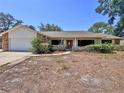 Charming single-story home with a brick and stucco facade and a well-manicured front yard at 1742 Willa Cir, Winter Park, FL 32792