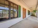 Inviting front porch with a decorative wood front door and large windows at 1742 Willa Cir, Winter Park, FL 32792