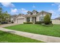 Beautiful one-story home boasts a lush lawn and a three-car garage at 1835 Southern Red Oak Ct, Ocoee, FL 34761