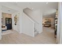 Hallway with staircase, wood-look tile flooring, and access to the living room at 2054 Education St, St Cloud, FL 34771