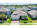Overhead view of well-manicured property showcasing the roof, lawn, and surrounding neighborhood at 2223 Blue Salvia St, Clermont, FL 34711