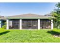 Enclosed back patio featuring outdoor seating with a hot tub and privacy at 2223 Blue Salvia St, Clermont, FL 34711