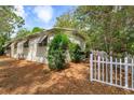 Side view of home, featuring a manicured yard with a charming white picket fence at 242 Peppertree Ct, Lake Mary, FL 32746