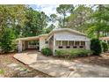 Inviting home featuring an enclosed porch with sunshades and a convenient carport at 242 Peppertree Ct, Lake Mary, FL 32746