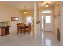 Bright dining area featuring tile floors, chandelier, and natural light from the front door at 244 Ballyshannon Dr, Davenport, FL 33897