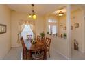 Cozy dining room with table for six, chandelier, and view of backyard at 244 Ballyshannon Dr, Davenport, FL 33897