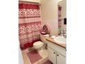 Bathroom with decorative shower curtain, toilet, and vanity with a well-lit mirror at 2514 Citrus Club Ln # 308, Orlando, FL 32839