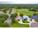 Aerial view of a single-Gathering home near a golf course and tree lined streets at 300 Churchill Dr, Longwood, FL 32779
