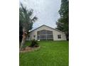 Backyard view of home featuring a large screened in porch and well manicured lawn at 300 Churchill Dr, Longwood, FL 32779