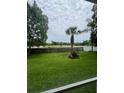 Spacious backyard with lush lawn, mature trees, and a sturdy wooden fence at 300 Churchill Dr, Longwood, FL 32779