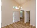 Bright entryway with neutral walls, modern lighting and wood laminate flooring at 300 Churchill Dr, Longwood, FL 32779