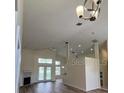 Open-concept living space with fireplace, high ceilings, and access to the backyard at 300 Churchill Dr, Longwood, FL 32779