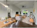 Bright, open-concept living room with new flooring, contemporary furnishings, and a ceiling fan at 3321 Crimson Ln, Deltona, FL 32738