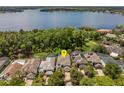 Breathtaking aerial view of a lakefront home nestled among lush trees at 334 N Shadowbay Blvd, Longwood, FL 32779