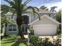 Beautiful two-story home with a well-maintained lawn, mature landscaping and a two car garage at 334 N Shadowbay Blvd, Longwood, FL 32779