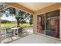Relaxing screened patio with seating, overlooking a tranquil pond at 4249 Andover Cay Blvd, Orlando, FL 32825