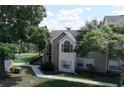 Attractive condo showcasing manicured lawn, mature trees and a classic architectural style at 4704 Walden Cir # 21, Orlando, FL 32811