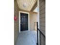 Unit 1921 has a clean black front door with a white trim and a gray concrete entry area at 4704 Walden Cir # 21, Orlando, FL 32811