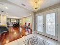 Elegant foyer featuring decorative tile, chandelier, and an archway to the dining area at 5127 Leeward Way, Orlando, FL 32809