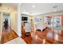 Bright living room with hardwood floors and sliding glass doors leading to an outdoor pool at 5127 Leeward Way, Orlando, FL 32809