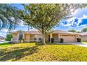 Charming single-story home showcasing a well-manicured lawn and attached two car garage at 554 Appleton Pl, Oviedo, FL 32765