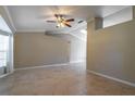 Spacious living room with ceramic tile flooring, ceiling fan, and natural light at 554 Appleton Pl, Oviedo, FL 32765
