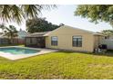 A pristine backyard showcasing a swimming pool, screened-in patio, and green grass at 5547 Garden Grove Cir, Winter Park, FL 32792