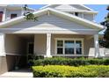 Charming exterior with lush landscaping and a covered entryway, creating a warm and welcoming curb appeal at 5897 Soter Ln, Windermere, FL 34786