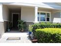 Inviting front porch with decorative plants and a charming welcome mat, creating a warm entrance at 5897 Soter Ln, Windermere, FL 34786
