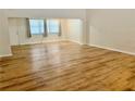 Open living room with hardwood floors, large windows, and lots of natural light at 650 Woodridge Drive, Fern Park, FL 32730