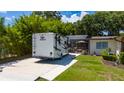 Exterior shot of a home with a large RV parked next to a screened in porch at 7 Westchester Dr, Kissimmee, FL 34744