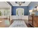 Elegant foyer with navy walls, white trim, hardwood floors, and stylish entry furnishings at 8812 S Bay Dr, Orlando, FL 32819