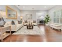 Bright living room featuring hardwood floors, neutral tones, and an inviting seating arrangement at 8812 S Bay Dr, Orlando, FL 32819