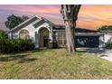 Charming single-story home with a well-maintained lawn and beautiful front yard landscaping at 1013 Silcox Branch Cir, Oviedo, FL 32765