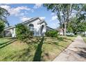 Beautiful single-story home with well-kept lawn and mature landscaping with a sidewalk on the street at 1013 Silcox Branch Cir, Oviedo, FL 32765