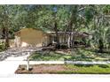 Inviting single-story home with a lush yard, featuring a stone facade and a sunny front at 107 Wayland Cir, Longwood, FL 32779
