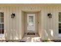 Welcoming front door with decorative glass and sconces, complemented by a 'Welcome' mat at 107 Wayland Cir, Longwood, FL 32779