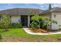 Inviting front yard with lush landscaping that frames the entryway at 11811 Scarecrow Ln, Orlando, FL 32821