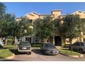 Well maintained tan building with mature landscaping, and parking at 120 Terrace Ridge Cir # 120, Davenport, FL 33896