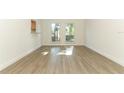 Sun-filled living room with new flooring and neutral walls at 1204 Duncan Ct, Longwood, FL 32779
