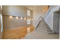 Bright living room featuring hardwood floors, a staircase, and an abundance of natural light at 12126 Diedra Ct, Orlando, FL 32825