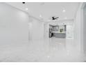 Bright, open-concept living area with modern gray kitchen and marble flooring at 13525 Se 100Th Ave, Belleview, FL 34420