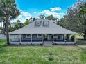 Beautiful home featuring a spacious porch, well-manicured lawn, and classic architectural details at 141 S Central Ave, Apopka, FL 32703