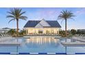 Resort-style zero-entry pool features ample lounge seating and a covered patio area for relaxing by the pool at 1832 Crowncrest Dr, Apopka, FL 32703