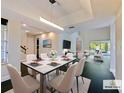 Staged dining room with seating for six, an open floorplan, hardwood floors, and a calming view of the outdoors at 208 Frinton Cv, Longwood, FL 32779