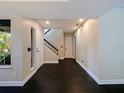 View of the home's entry foyer featuring fresh paint, hardwood floors, recessed lighting, and staircase to the upper level at 208 Frinton Cv, Longwood, FL 32779