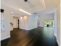 Bright open-concept living room with black hardwood floors, recessed lighting, and neutral paint colors throughout at 208 Frinton Cv, Longwood, FL 32779
