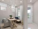 Inviting foyer featuring a front door with decorative glass, stylish lighting, and elegant decor at 2333 Daisy Tree Rd, St Cloud, FL 34771