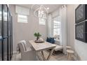 Inviting foyer featuring a front door with decorative glass, stylish lighting, and elegant decor at 2333 Daisy Tree Rd, St Cloud, FL 34771